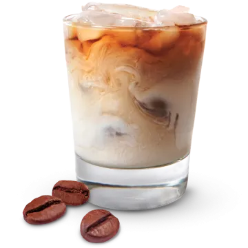 a glass filled with ice and coffee beans