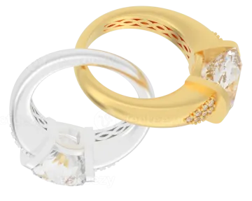 a pair of gold and silver wedding rings