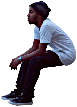 a man sitting on top of a skateboard