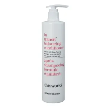 a bottle of hair products with the words in red and white