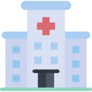 a hospital building with a red cross on top