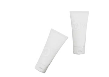 a white tube of toothpas on a piece of paper