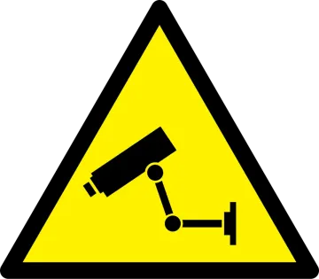 a yellow and black sign with a camera