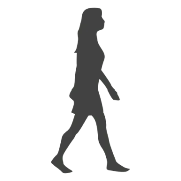 a silhouette of a woman walking down the street