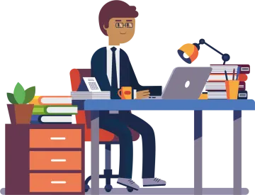 a man is sitting at the desk and working on his laptop