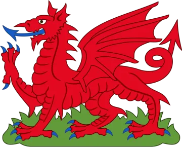 a red dragon sitting on top of grass