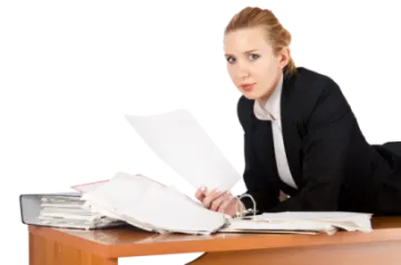 a woman sitting at a desk with papers