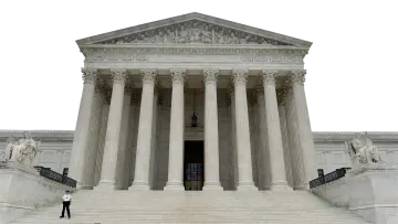 a man standing in front of a large building