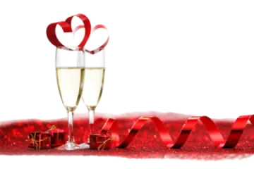a glass of champagne with a red ribbon around it