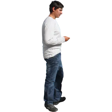 a man in a white shirt and blue jeans looking at his cell