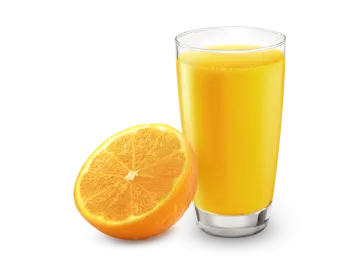 a glass of orange juice next to an orange