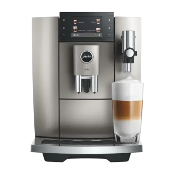 a coffee machine with a glass of milk