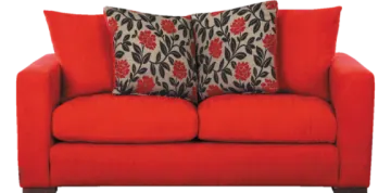 a red couch with two pillows on it
