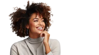 a woman with curly hair smiling and looking up