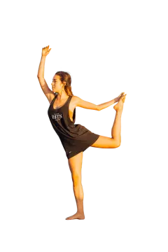 a woman in a black shirt is doing a kick