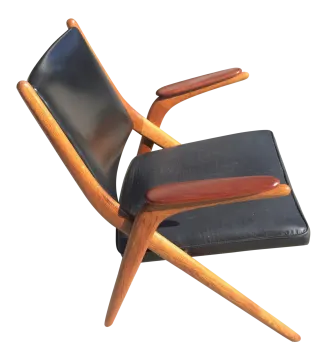 a black leather and wood lounge chair