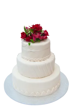 a white wedding cake with red flowers on top