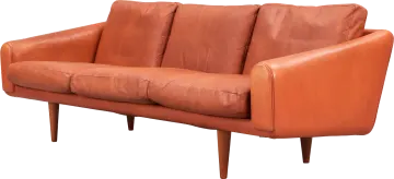 an orange leather sofa with wooden legs