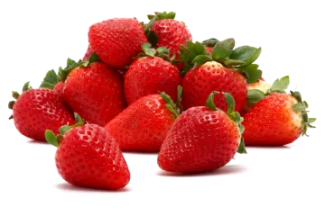 a pile of strawberries with green leaves