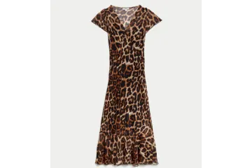 a woman wearing a leopard print dress