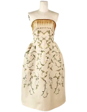 a white dress with floral embroidery on it