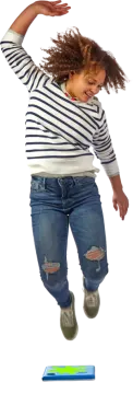a young girl jumping in the air with her arms outstretched