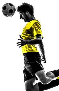 a man kicking a soccer ball in the air