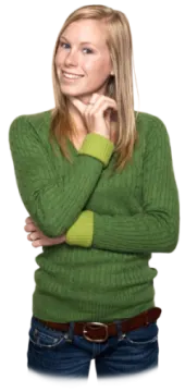 a woman wearing a green sweater and jeans