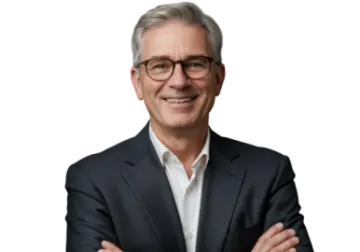 a man in a suit and glasses with his arms crossed
