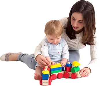a woman playing with a child on the floor