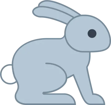 a gray rabbit sitting down on the ground