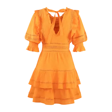 a woman wearing an orange dress with lace detailing