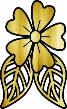 a gold flower with leaves on it