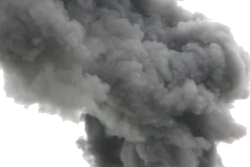 black smoke bills from the top of a building