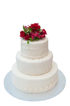 a white wedding cake with red flowers on top