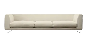 a white couch with two pillows on it