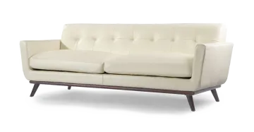 a white leather sofa with wooden legs and arms