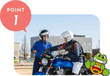 two people wearing helmets on a motorcycle