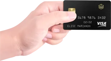 a hand holding a black credit card