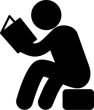 a person sitting on the ground reading a book