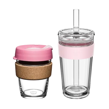 a glass cup with a pink lid and cork lid