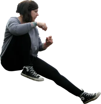 a young girl is flying through the air