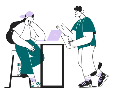 two people sitting at a table with laptops
