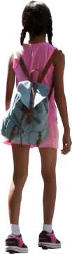 a little girl in a pink dress and white shoes