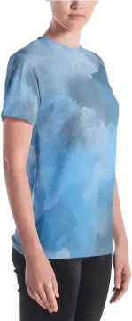 a woman wearing a blue t - shirt with clouds on it