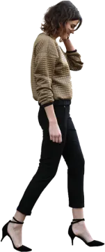 a woman in black pants and a brown sweater