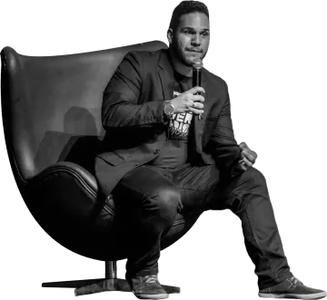 a black and white photo of a man sitting in a chair