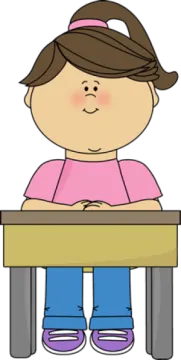 a little girl sitting at her desk