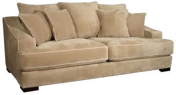 a tan colored couch with pillows on it