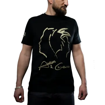 a man wearing a black t - shirt with gold foil on it